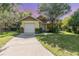 Charming single Gathering home featuring a one car garage and well maintained lawn with mature trees at 1007 Glendale St, Orlando, FL 32807