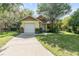 Charming single Gathering home featuring a one car garage and well maintained lawn with mature trees at 1007 Glendale St, Orlando, FL 32807