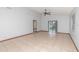 Bright living room features neutral tile floors, high ceilings, and sliding glass doors to the backyard at 1007 Glendale St, Orlando, FL 32807