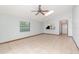 Spacious living room featuring tile flooring, skylight, ceiling fan, and a bar overlooking the kitchen at 1007 Glendale St, Orlando, FL 32807
