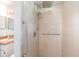 Bathroom featuring tiled walk-in shower with rainfall showerhead and grab bars for accessibility at 1007 Glendale St, Orlando, FL 32807