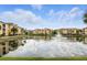 Scenic community lake view with lush landscaping, fountain, and yellow condos at 1125 Lake Shadow Cir # 5109, Maitland, FL 32751