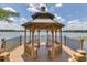 Wooden gazebo overlooking a serene lake, perfect for relaxation and enjoying nature at 1125 Lake Shadow Cir # 5109, Maitland, FL 32751