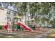Community playground area with slides, swings, and lush greenery at 1125 Lake Shadow Cir # 5109, Maitland, FL 32751