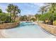Gorgeous community pool area surrounded by stone accents and lush tropical landscaping at 1125 Lake Shadow Cir # 5109, Maitland, FL 32751