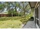 Large backyard with mature trees offering shade, showcasing a peaceful outdoor space ready for landscaping or recreation at 11540 Harbor Rd, Leesburg, FL 34788