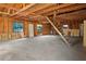 Unfinished basement presents exposed wood framing, concrete floor, and ample potential for customization and added living space at 11540 Harbor Rd, Leesburg, FL 34788
