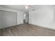 Large bedroom with wood-look floors, a ceiling fan, closet and an ensuite bath at 11540 Harbor Rd, Leesburg, FL 34788