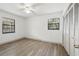 Comfortable bedroom with light, wood-look floors, two windows and spacious closet at 11540 Harbor Rd, Leesburg, FL 34788