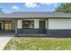 Charming home entrance with well-manicured lawn leading to carport at 11540 Harbor Rd, Leesburg, FL 34788