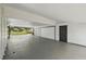 Large garage with new paint, offering ample parking and storage space at 11540 Harbor Rd, Leesburg, FL 34788