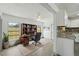 Home office featuring a built-in bookcase and desk adjoining a modern kitchen at 11540 Harbor Rd, Leesburg, FL 34788