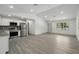 Bright, open-concept kitchen with stainless steel appliances and new flooring at 11540 Harbor Rd, Leesburg, FL 34788