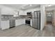 Modern kitchen with stainless steel appliances and new flooring at 11540 Harbor Rd, Leesburg, FL 34788
