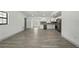 Expansive living room offers new gray flooring and fresh white paint, providing a bright and airy space at 11540 Harbor Rd, Leesburg, FL 34788