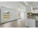 Bright, open living space adjacent to the kitchen with light gray floors and white walls at 11540 Harbor Rd, Leesburg, FL 34788