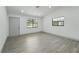 Bright, airy living room with new gray flooring, fresh paint, and large windows for natural light at 11540 Harbor Rd, Leesburg, FL 34788