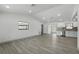Spacious living room features new flooring and fresh paint, complemented by a large window at 11540 Harbor Rd, Leesburg, FL 34788