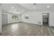 Spacious living area featuring light wood-look floors, recessed lighting, and ample natural light at 11540 Harbor Rd, Leesburg, FL 34788