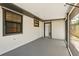 Enclosed porch with large windows and access to the home, painted in neutral tones offering a clean and inviting space at 11540 Harbor Rd, Leesburg, FL 34788