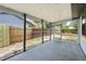 Screened porch offers outdoor living with views of the fenced backyard, a relaxing space for enjoying nature at 11540 Harbor Rd, Leesburg, FL 34788