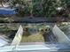An outdoor fenced-in backyard with grass and an adjacent wooded area at 1205 Southstation Pl # 208, Orlando, FL 32809