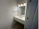 Modern bathroom features updated vanity with a large mirror and contemporary lighting at 1205 Southstation Pl # 208, Orlando, FL 32809