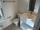A clean, well-lit bathroom with modern fixtures and a vanity with storage at 1205 Southstation Pl # 208, Orlando, FL 32809