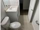 Contemporary bathroom featuring white toilet, sink with storage and tile floor at 1205 Southstation Pl # 208, Orlando, FL 32809
