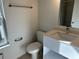 A well-lit bathroom with a toilet, vanity and a window letting in natural light at 1205 Southstation Pl # 208, Orlando, FL 32809