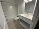 Bright bathroom with shower-tub, large mirror and quartz vanity at 1205 Southstation Pl # 208, Orlando, FL 32809