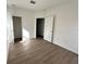 An inviting bedroom with wood floors and plenty of open space and natural light at 1205 Southstation Pl # 208, Orlando, FL 32809