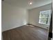 This bedroom features wood floors, neutral walls, and a bright window view at 1205 Southstation Pl # 208, Orlando, FL 32809