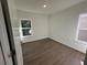 A bedroom with wood floors and natural light, featuring a modern aesthetic at 1205 Southstation Pl # 208, Orlando, FL 32809