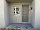Charming gray front entrance with brick pavers and a sidelight window at 1205 Southstation Pl # 208, Orlando, FL 32809