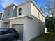 Modern home featuring a gray garage and neutral paint at 1205 Southstation Pl # 208, Orlando, FL 32809