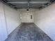 Spacious two-car garage featuring ample space for vehicles and storage at 1205 Southstation Pl # 208, Orlando, FL 32809