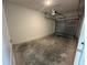 Attached one-car garage with a concrete floor at 1205 Southstation Pl # 208, Orlando, FL 32809