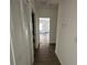 Hallway with wood flooring and closed bi-fold doors at 1205 Southstation Pl # 208, Orlando, FL 32809