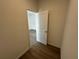 Hallway leading to another room, showcasing the flooring and overall layout at 1205 Southstation Pl # 208, Orlando, FL 32809