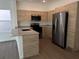 Well-lit kitchen with stainless steel appliances, granite countertops, and wood-style cabinets at 1205 Southstation Pl # 208, Orlando, FL 32809