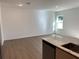 Bright living room featuring luxury vinyl plank floors and lots of natural light at 1205 Southstation Pl # 208, Orlando, FL 32809