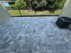 View of fenced paver patio overlooking greenery and features A/C unit at 1205 Southstation Pl # 208, Orlando, FL 32809