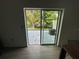View of the patio with gray pavers, an air conditioning unit, and sliding glass door to the home's interior at 1205 Southstation Pl # 208, Orlando, FL 32809