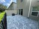 Exterior view of patio with gray pavers, fence, A/C unit, and sliding glass door at 1205 Southstation Pl # 208, Orlando, FL 32809