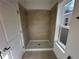 Shower with tile surround and a window for natural light, with a walk-in design at 1205 Southstation Pl # 208, Orlando, FL 32809