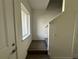 Stairwell with hardwood flooring, white walls, and a window for natural lighting at 1205 Southstation Pl # 208, Orlando, FL 32809