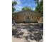 Modest yellow single-story home with symmetrical facade and a front parking area at 1218 37Th St, Orlando, FL 32805