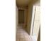 Hallway with beige colored walls and neutral tile flooring throughout the passage at 1218 37Th St, Orlando, FL 32805