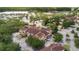Overhead shot of community apartments with well maintained landscaping, parking, and shopping center at 12414 Baleria Cv # 104, Orlando, FL 32837